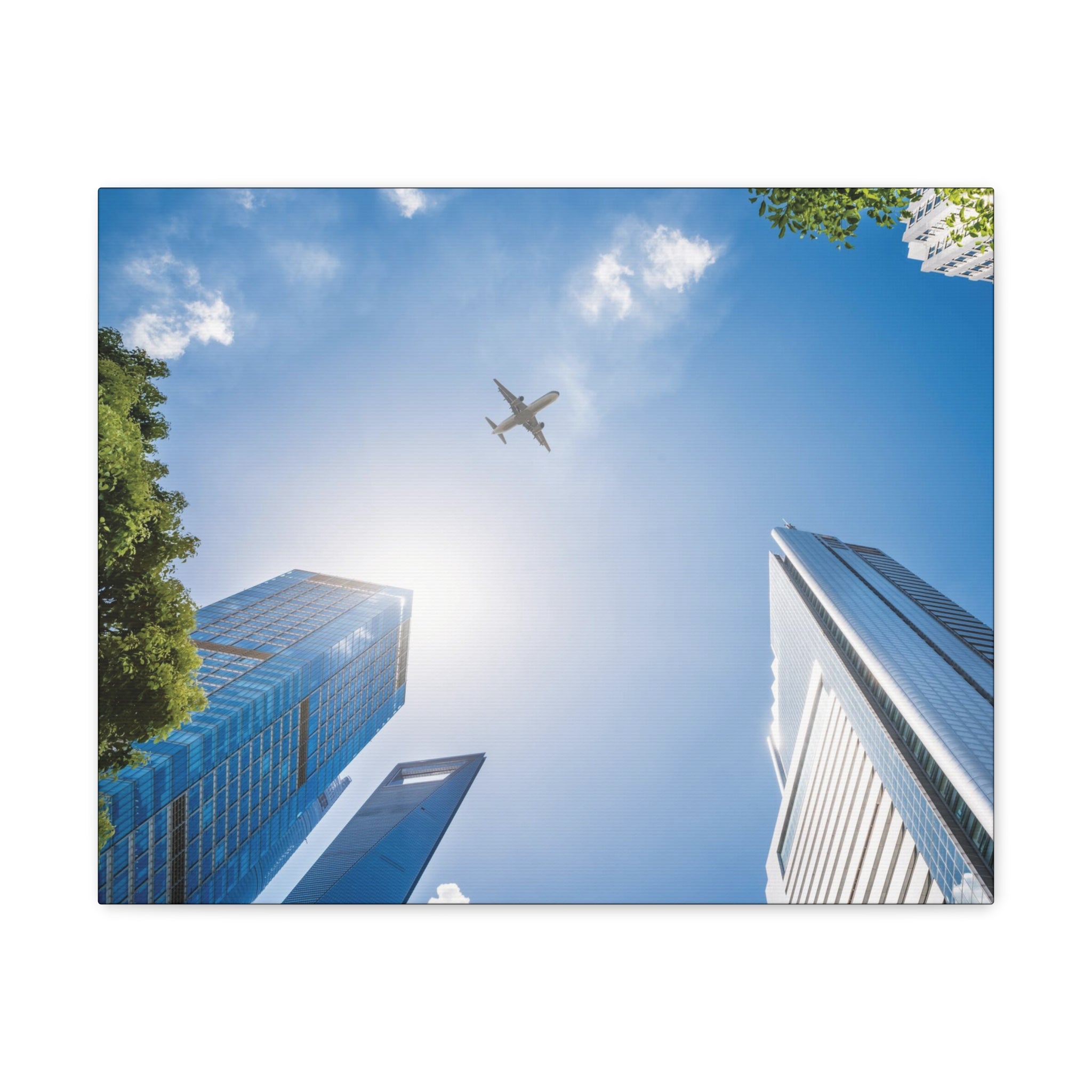 Airplane Flying Over Buildings Canvas Gallery Wrap